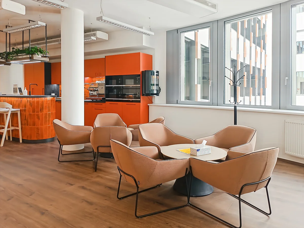 Lounge seating area with kitchen in background